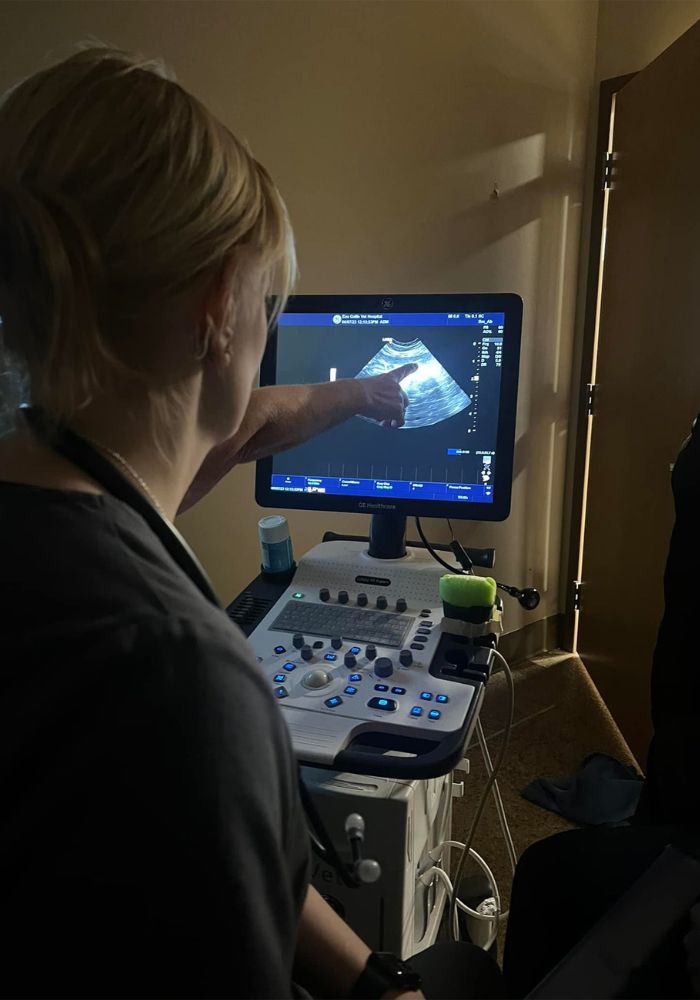 a person is using an ultrasound machine in a room